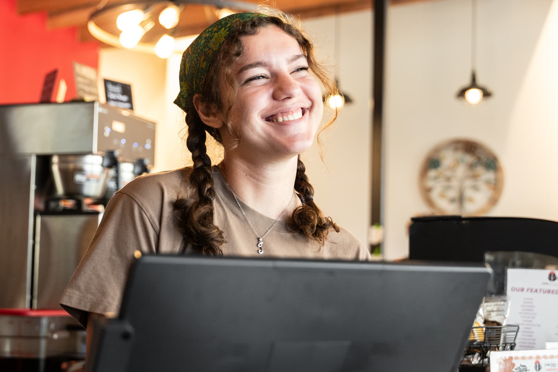 Smiling barista at the register at High Grounds Coffee Roasters, Glassboro