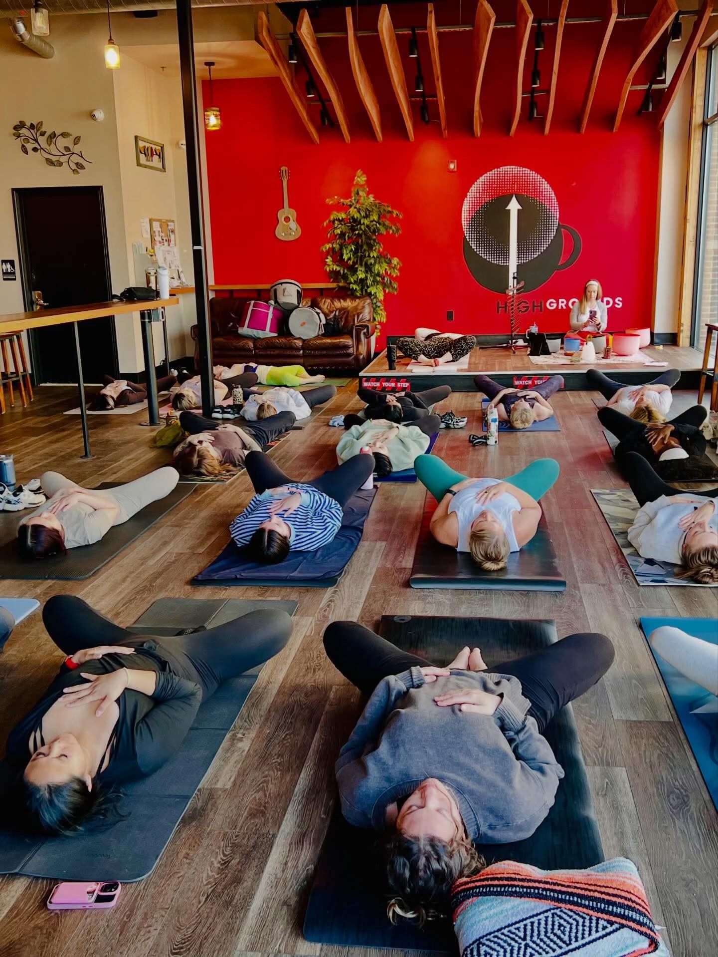 Guests lying on mats during a sound bath at High Grounds Coffee Roasters in Glassboro