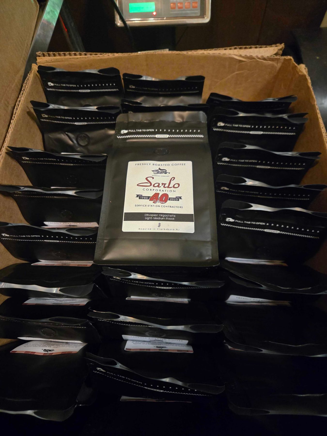 Box of custom-labeled coffee bags roasted for a local company's 40th anniversary