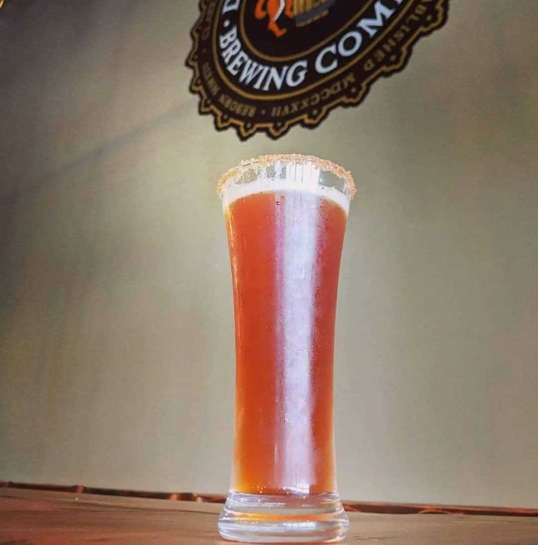 Sugar-rimmed amber beer beneath the Death of the Fox crest