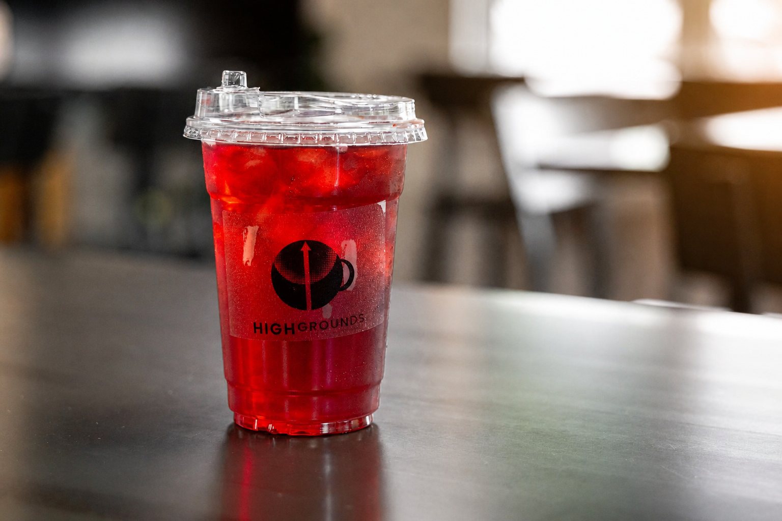 Bright red iced refresher in a High Grounds cup