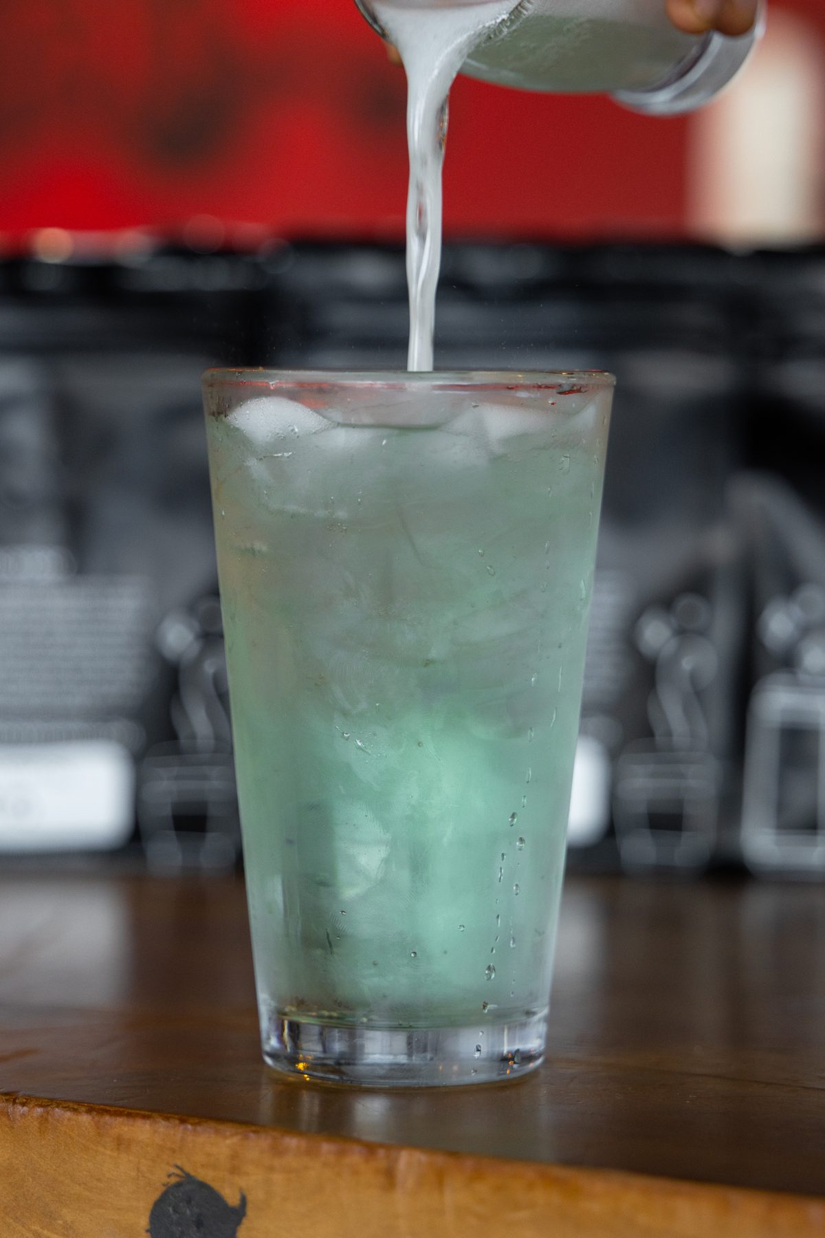 Iced specialty coffee drink being poured