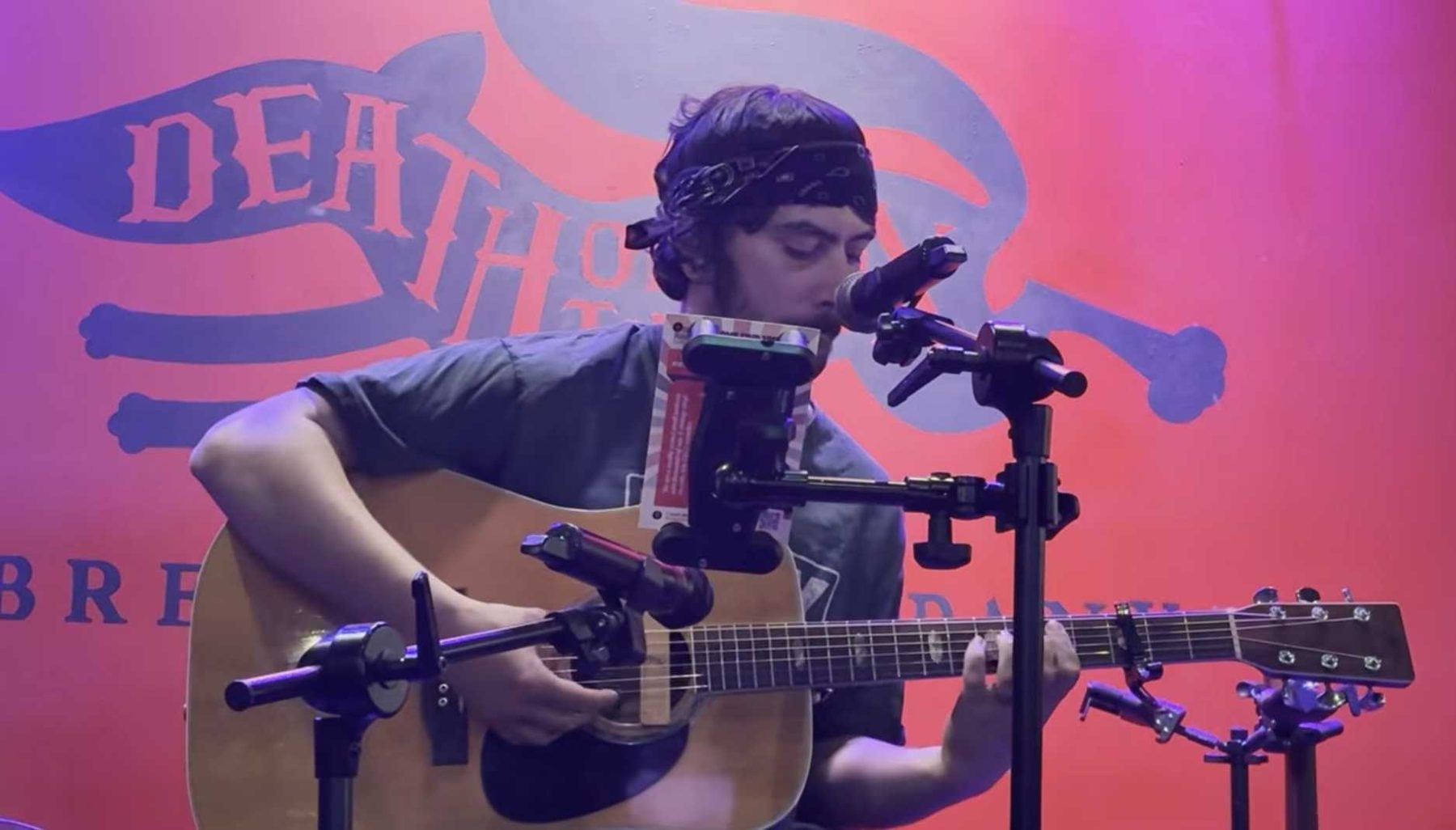 Acoustic guitarist in a bandana performing at Death of the Fox