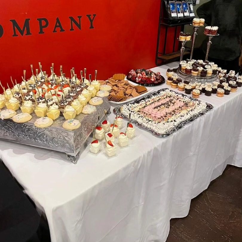Dessert table set up for an event beneath the Death of the Fox sign