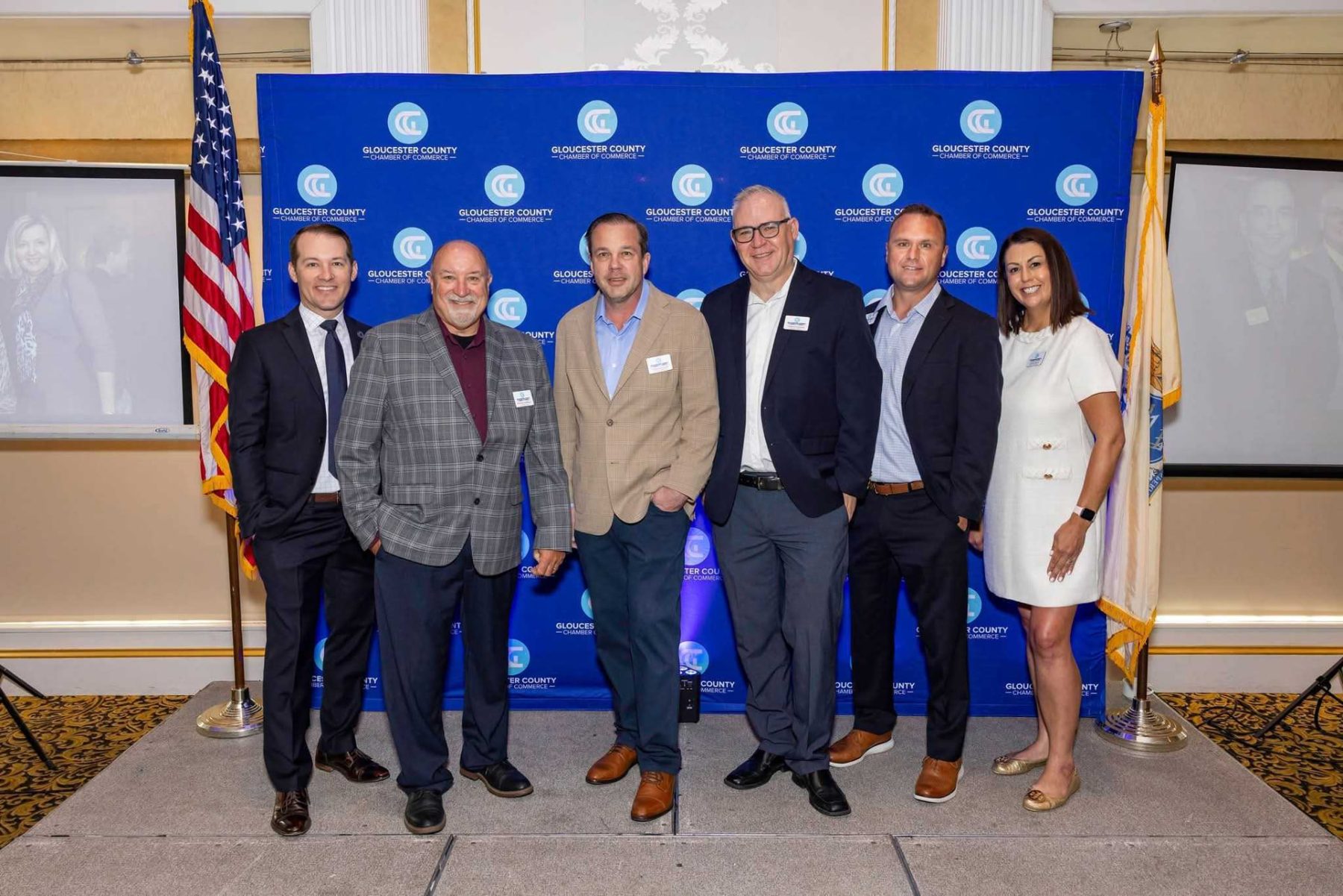 Gloucester County Chamber of Commerce leaders posing together in front of the chamber backdrop