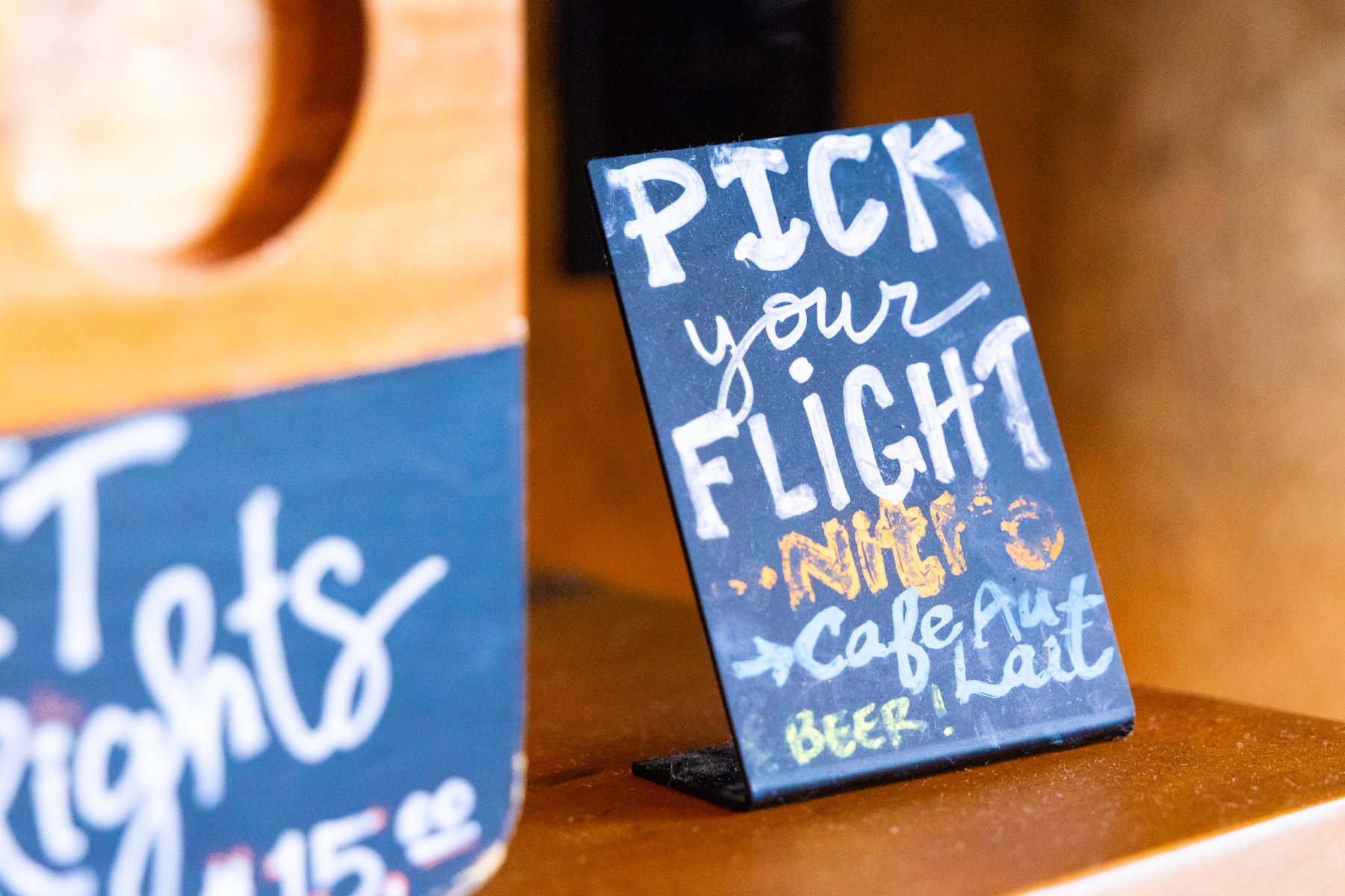 Pick your flight sign at the Death of the Fox bar