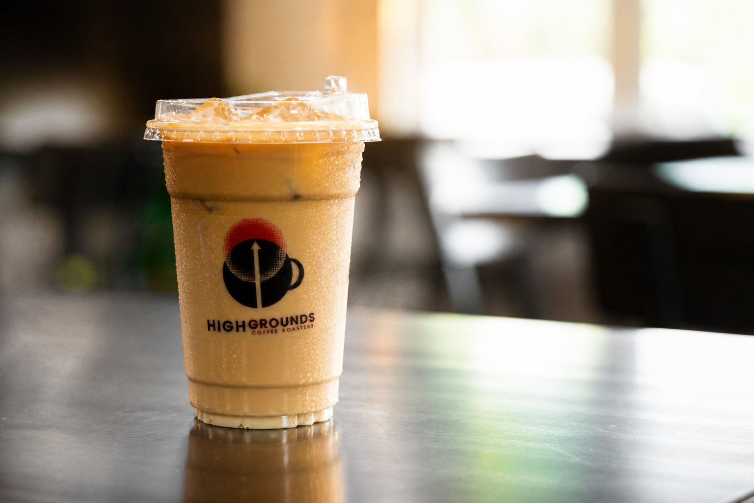 Iced latte in a branded High Grounds cup