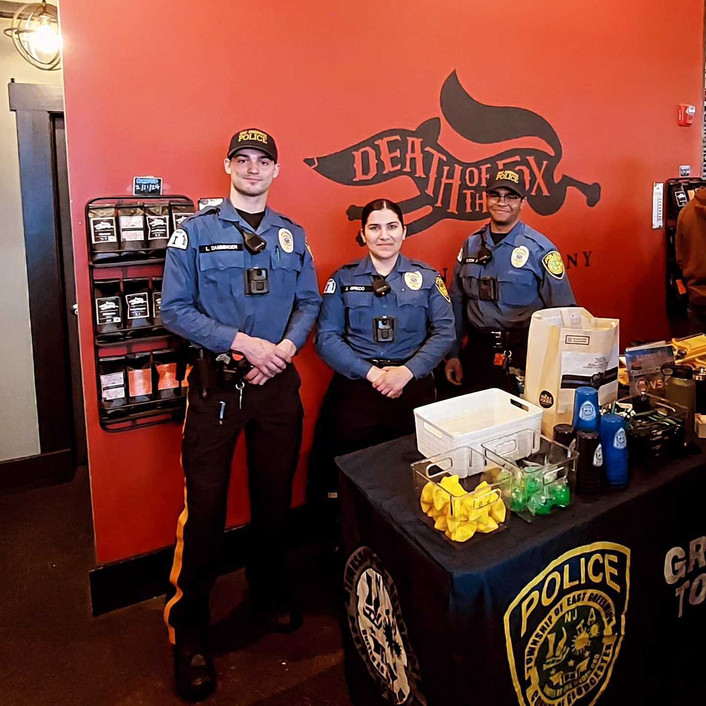 East Greenwich police officers at a community table in the Death of the Fox taproom