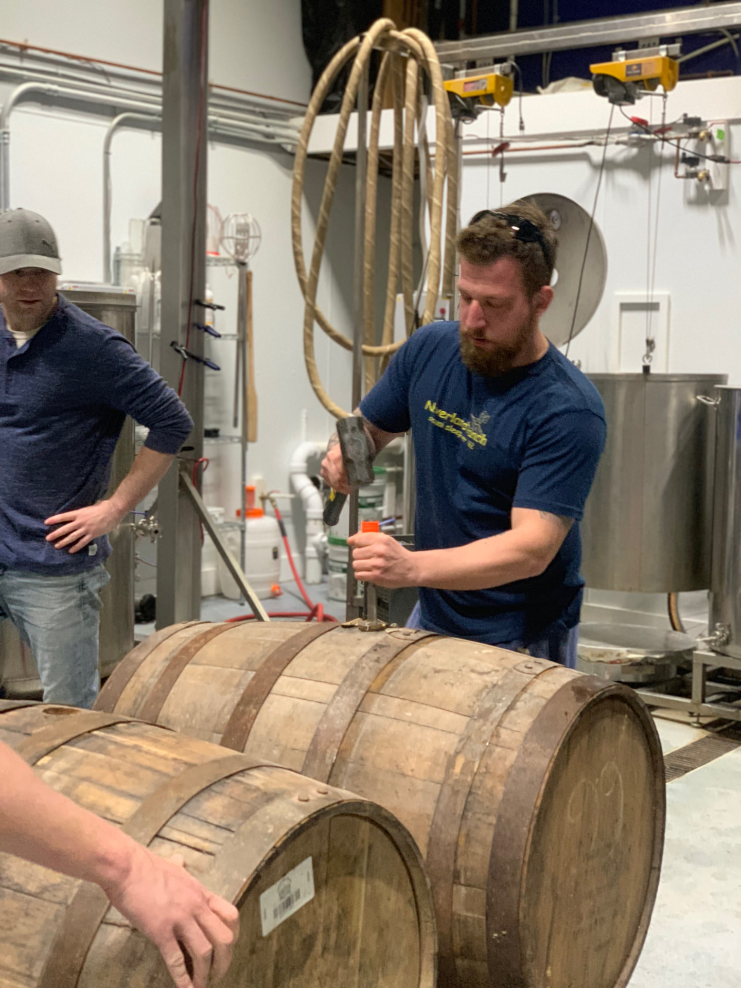 Brewers tapping oak barrels in the Death of the Fox brewhouse